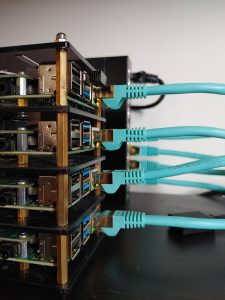 An image of 4 Raspberry Pi boards connected by a POE capable switch